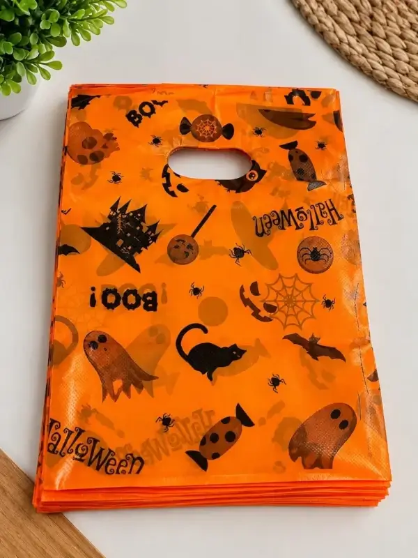Bolsa plástica naranja con manija troquelada, fantasmas y gatos de Halloween